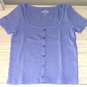 Blue Hollister short-sleeve top with button detailing.